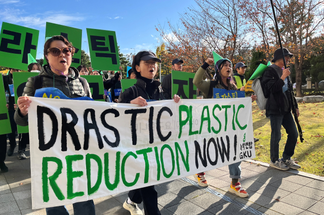Climate activists march on a street to demand stronger global commitments to fight plastic waste at the Intergovernmental Negotiating Committee (INC-5), in Busan, South Korea, 
November 23, 2024. REUTERS/Minwoo Park