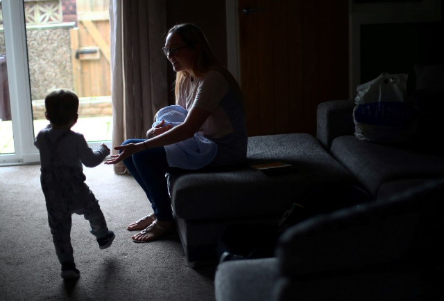 A mother introduces her baby, who was born prematurely and is now nine weeks old, to his older brother for the first time after being discharged from the Lancashire Women and Newborn Centre of Burnley General Hospital in East Lancashire in Burnley, Britain, June 22, 2020. REUTERS/Hannah McKay