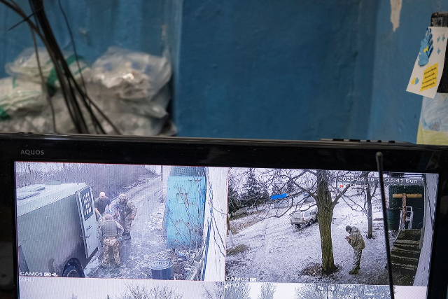 Medics are seen in a surveillance monitor as they bring patients inside the frontline medical stabilisation point where they treat war wounds, amid Russia's attack on Ukraine, near Vuhledar, Donetsk region, Ukraine, February 19, 2023