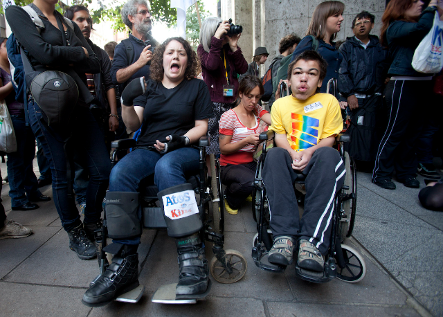 Protesters demonstrate against IT company Atos's involvement in tests for incapacity benefits outside the Department for Work and Pensions in London August 31, 2012. REUTERS/Neil Hall