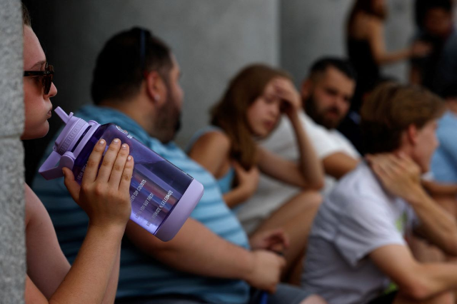 A woman drinks water amid a heatwave in Madrid, Spain, July 17, 2023