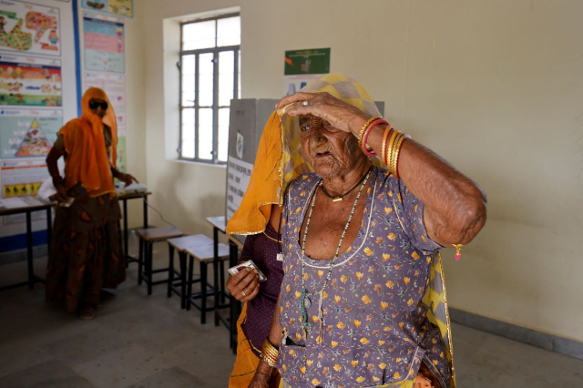 A woman leaves after casting her vote at a polling station during the first phase of the general election, in Bikaner district, Rajasthan, India, April 19, 2024. REUTERS/Amit Dave