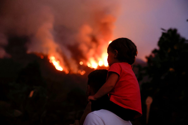 Residents of the town of Aguamansa watch the wildfires rage out of control on the island of Tenerife, Canary Islands, Spain August 17, 2023