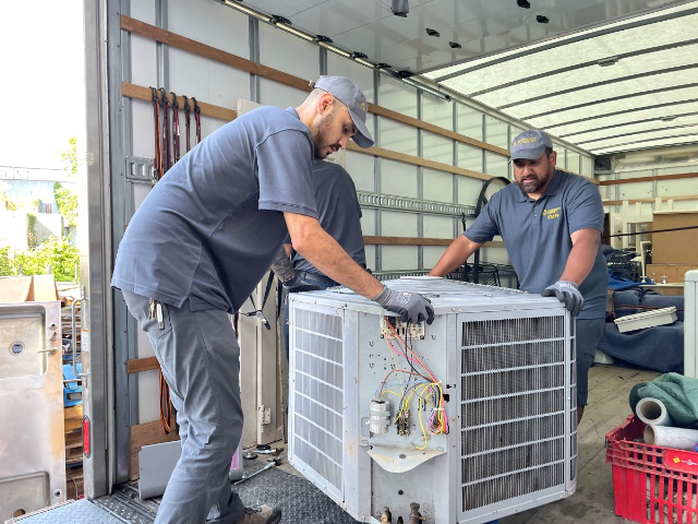 Workers unload items from a deconstruction project at a reuse store in Edmonston, Maryland. Community Forklift/Handout via Thomson Reuters Foundation