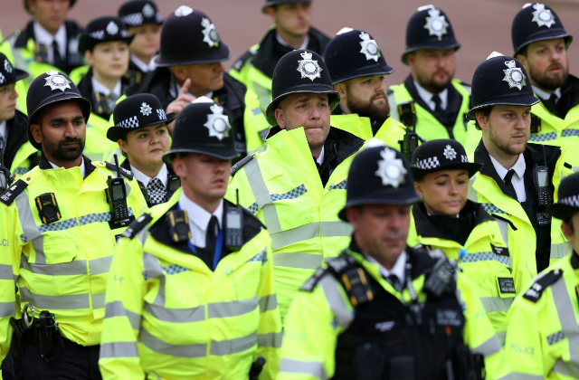 Metropolitan Police officers march along the route of the 'King's Procession', in central London, on May 6, 2023, ahead of the Coronation of King Charles III