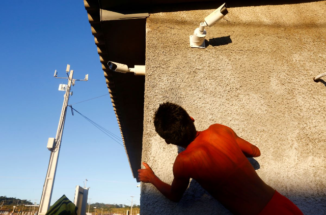 A child is seen near CCTV cameras near the Teles Pires river, in the Alta Floresta city, in the north of the state of Mato Grosso in the Amazon, Brazil July 16, 2017