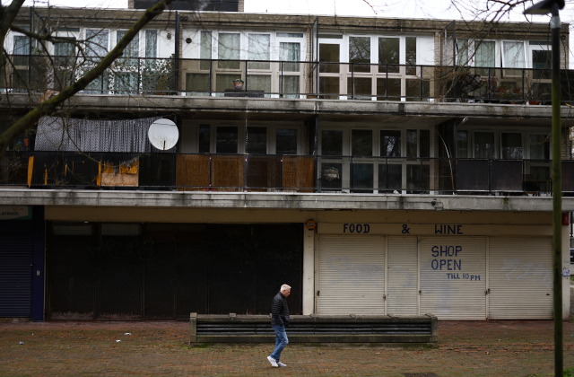 A man walks past closed down shops on a housing estate in south London, Britain, February 26, 2024. REUTERS/Hannah McKay