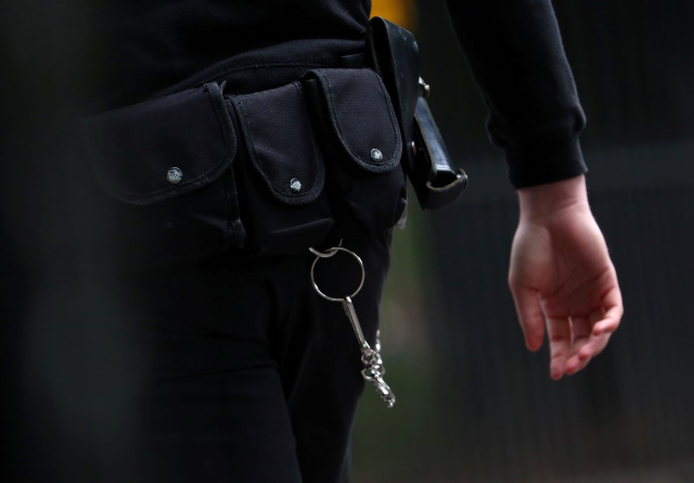 A prison officer stands outside Wormwood Scrubs Prison in London, Britain, September 14, 2018. REUTERS/Hannah McKay