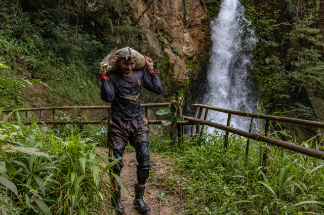 A mine worker carries a sack filled with rock chunks suspected to contain gold in Citorek Kidul, Banten, Indonesia, July 14, 2025. Thomson Reuters Foundation/Yudha Baskoro