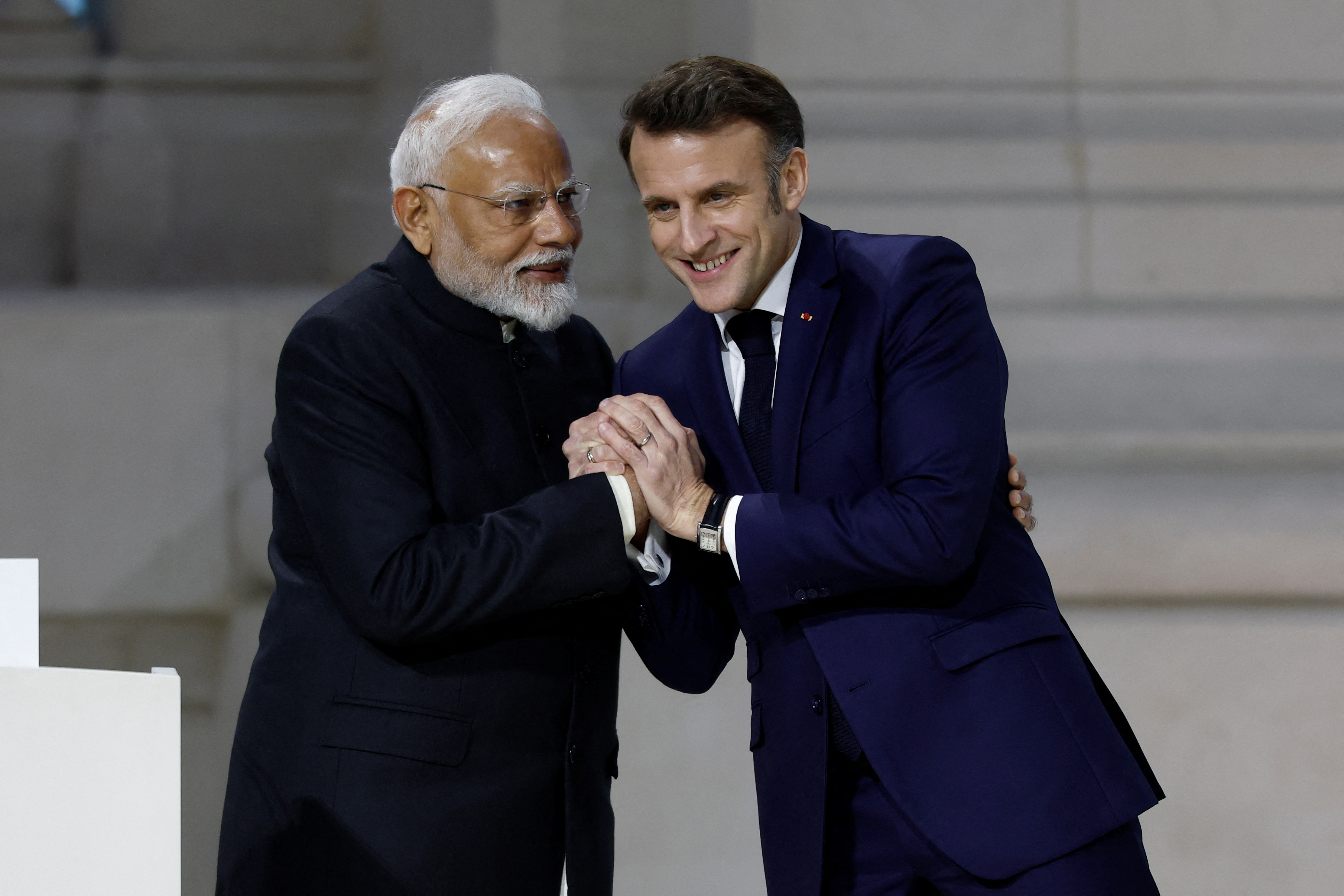 French President Emmanuel Macron shakes hands with Indian Prime Minister Narendra Modi at the Artificial Intelligence (AI) Action Summit at the Grand Palais in Paris, France, February 11, 2025. REUTERS/Benoit Tessier