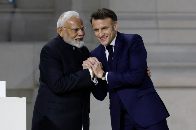 French President Emmanuel Macron shakes hands with Indian Prime Minister Narendra Modi at the Artificial Intelligence (AI) Action Summit at the Grand Palais in Paris, France, February 11, 2025. REUTERS/Benoit Tessier