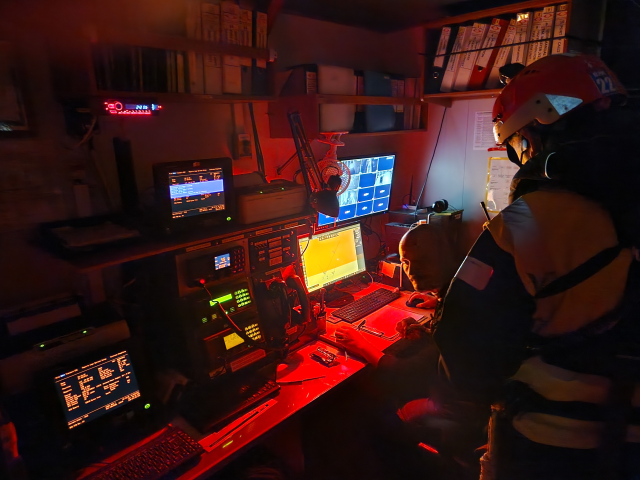 Deputy Search and Rescue Coordinator Alessandro and rescue team leader Tanguy track a boat in distress on board the Ocean Viking, December 27, 2022. Thomson Reuters Foundation/Frey Lindsay