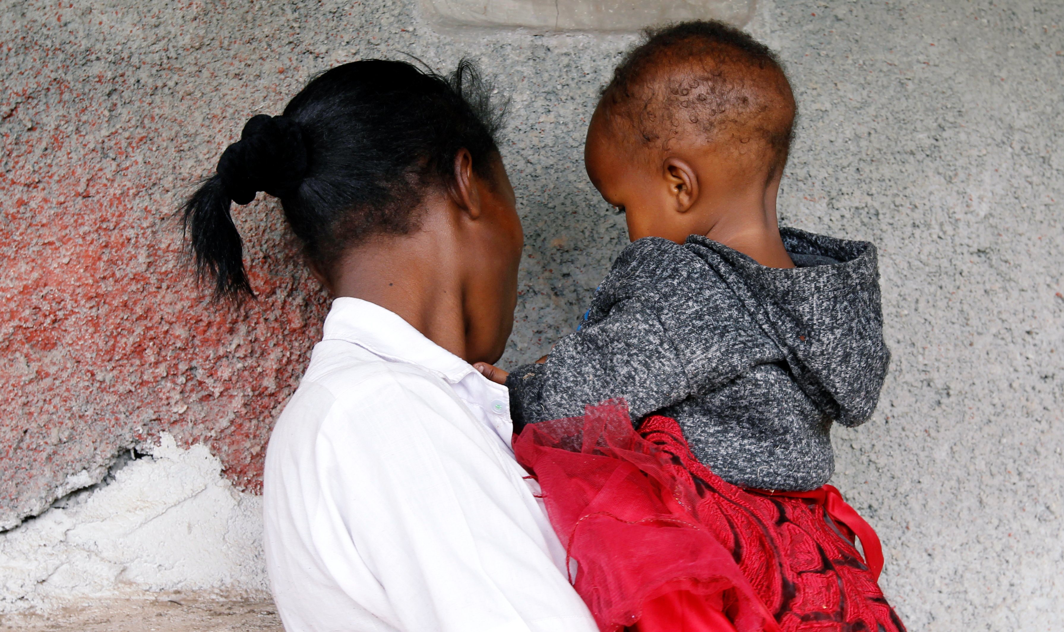A 19-year-old carries her child outside a secondary school which accommodates pregnant girls and teenage mothers with their babies in Nyeri, Kenya January 8, 2021.  REUTERS/Monicah Mwangi