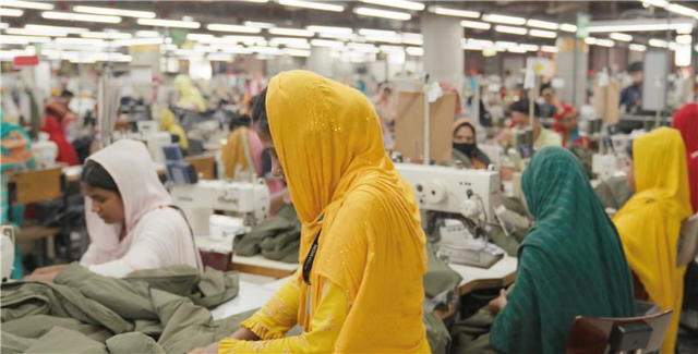 Garment workers work in factory. Thomson Reuters Foundation/Albert Han