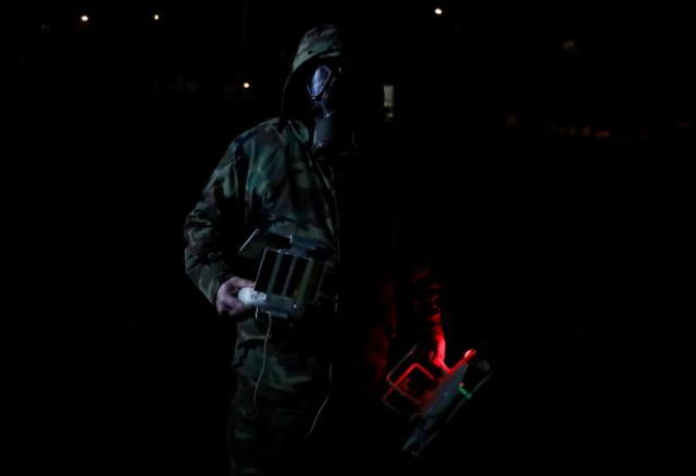A Greek security member holds a drone as he patrols near Turkey's Pazarkule border crossing, in Kastanies, Greece March 12, 2020. REUTERS/Florion Goga