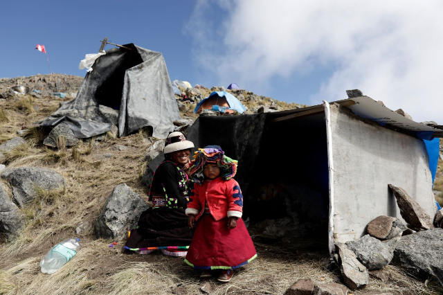 An indigenous woman and her daughter protest to demand the land they call ancestral lands, to be returned to the communities, in Apurimac, Peru, May 9, 2022. REUTERS/Angela Ponce