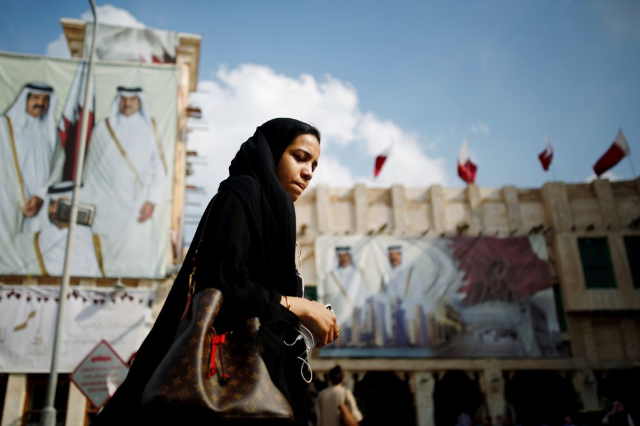 A young woman walks at Souq Waqif, a marketplace in Doha, Qatar, December 19, 2019