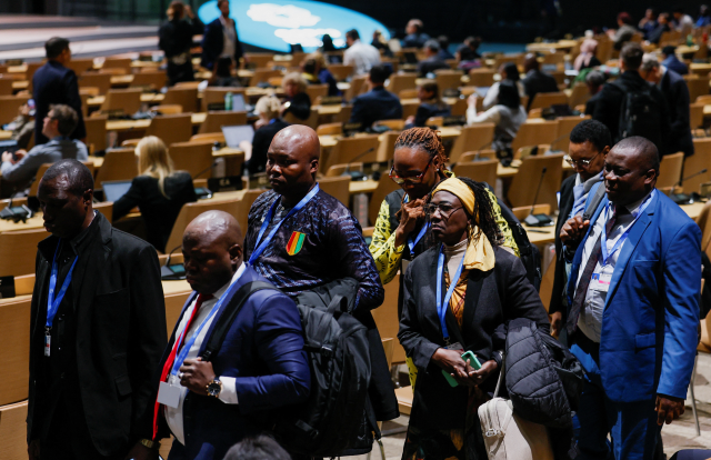 Delegates leave a hall after listening to statements from speakers at COP29, in Baku, Azerbaijan November 19, 2024. REUTERS/Maxim Shemetov