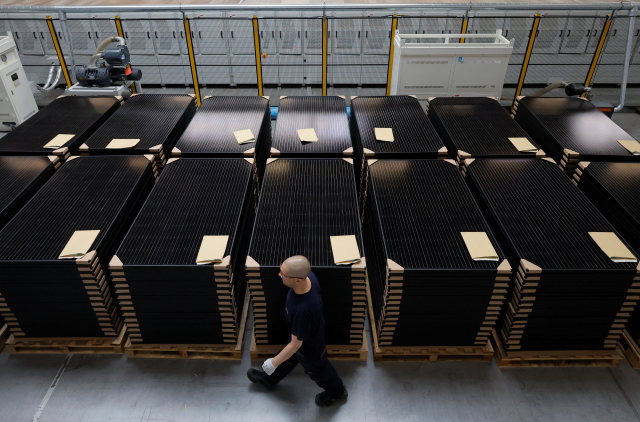 An employee works on a solar panel production line at the Systovi factory in Carquefou near Nantes, France, March 29, 2024. REUTERS/Stephane Mahe