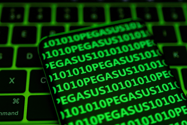 The word Pegasus and binary code are displayed on a smartphone which is placed on a keyboard in this illustration taken May 4, 2022. REUTERS/Dado Ruvic