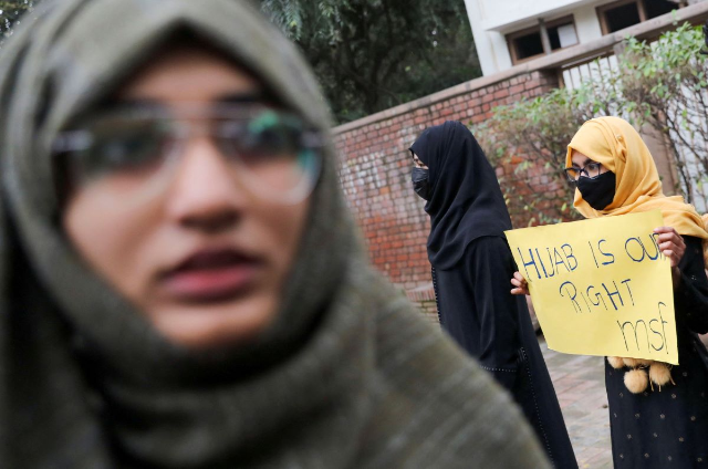 A Muslim student holds a placard during a protest by Muslim Students Federation (MSF) against the recent hijab ban in a few of Karnataka's colleges, in New Delhi, India, February 8, 2022. REUTERS/Anushree Fadnavis