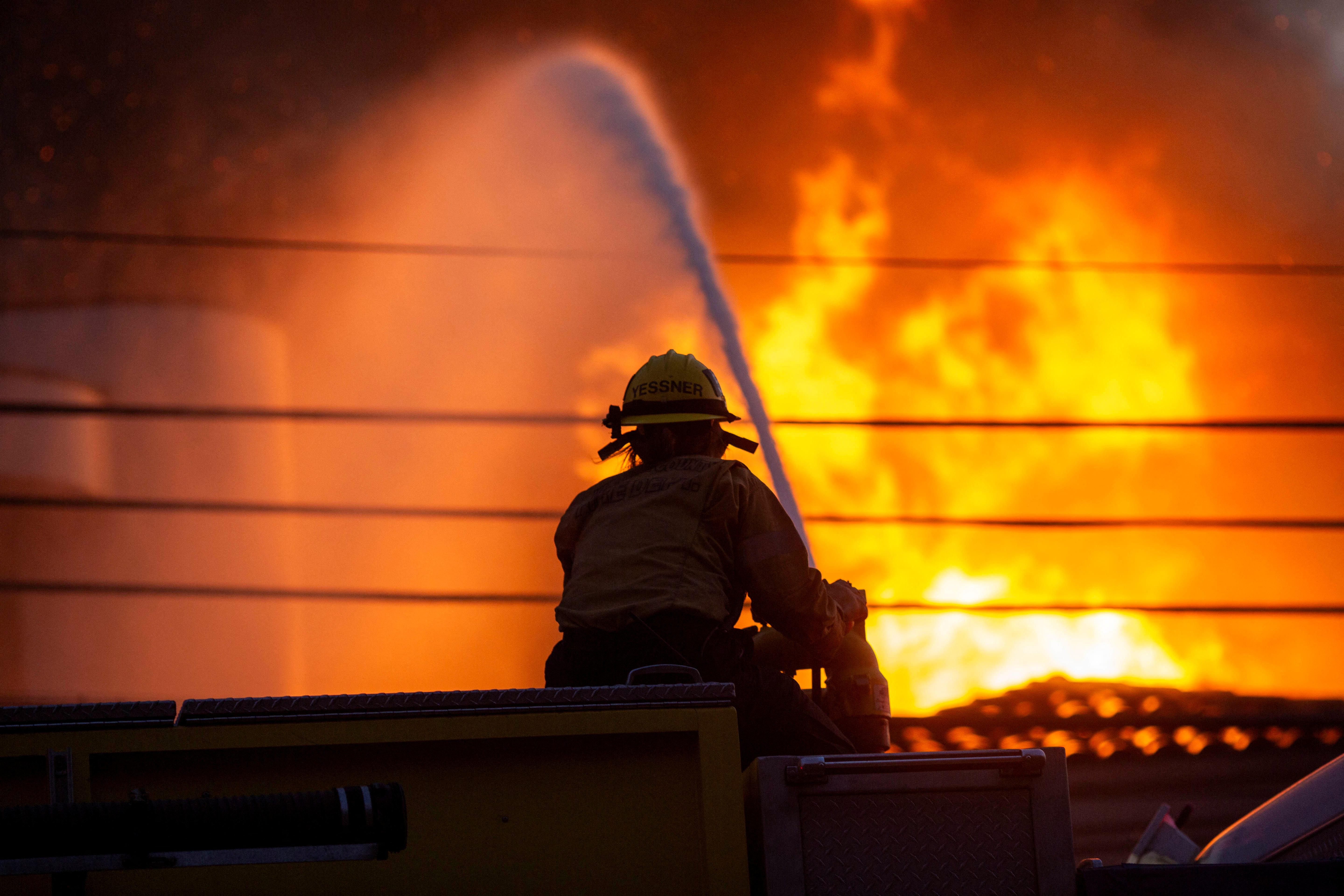 A firefighter battles the Palisades Fire as it burns during a windstorm on the west side of Los Angeles, California, U.S. January 8, 2025. REUTERS/Ringo Chiu