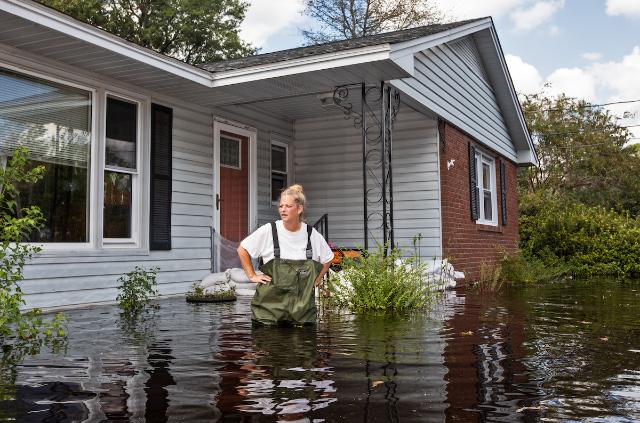 A woman checks on flood damage in Conway, South Carolina, USA almost two weeks after Hurricane Florence hit, on Sept. 26, 2018. Thomson Reuters Foundation/Julie Dermansky